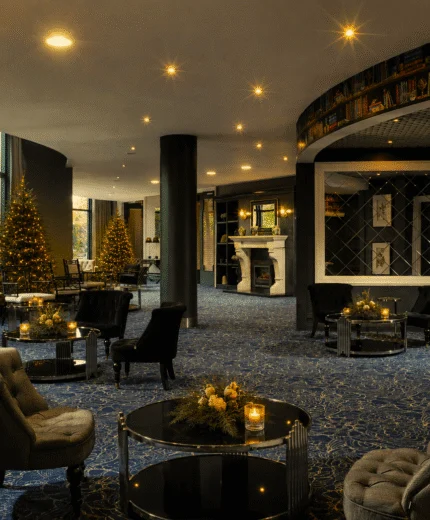 Cozy hotel lounge with comfortable seating and festive decorations.
