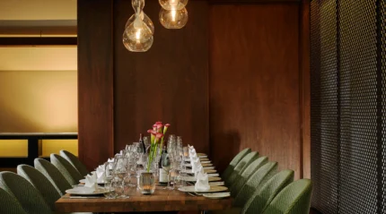 Table set for a family dinner in a cosy, elegant dining room with soft lighting.
