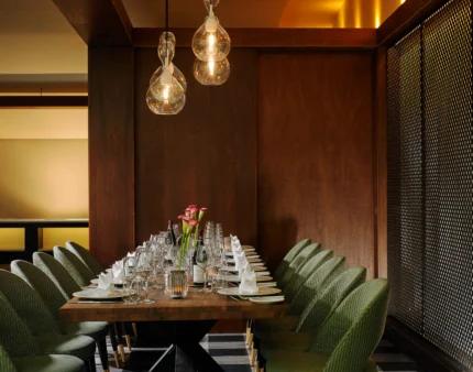 Table set for a family dinner in a cosy, elegant dining room with soft lighting.