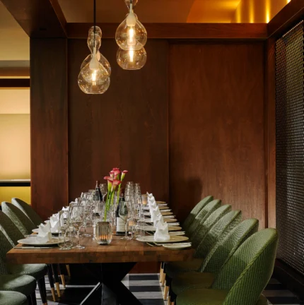 Table set for a family dinner in a cosy, elegant dining room with soft lighting.