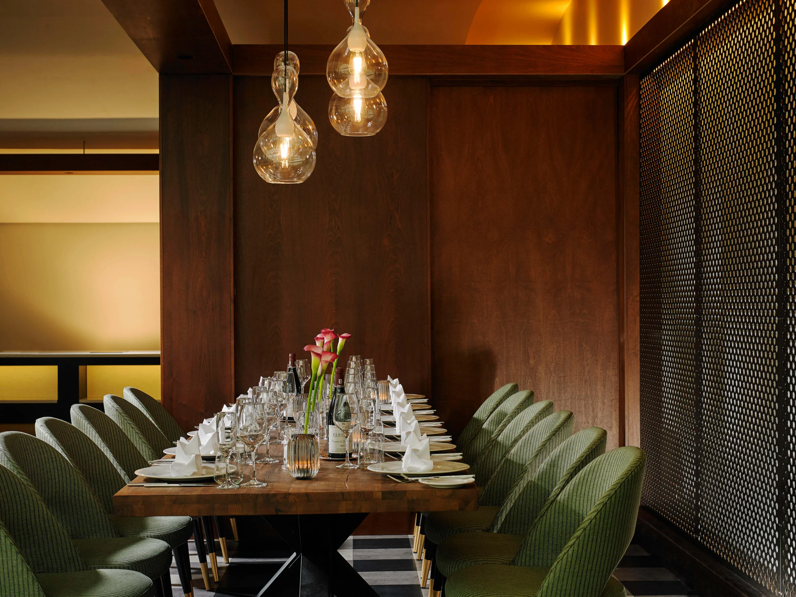 Table set for a family dinner in a cosy, elegant dining room with soft lighting.