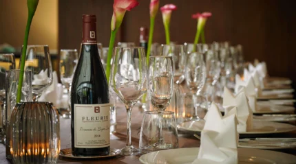 Elegant table setting with wine and flowers, perfect for a family gathering at a resort.