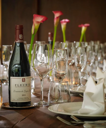 Elegant table setting with wine and flowers, perfect for a family gathering at a resort.
