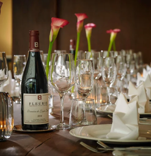 Elegant table setting with wine and flowers, perfect for a family gathering at a resort.