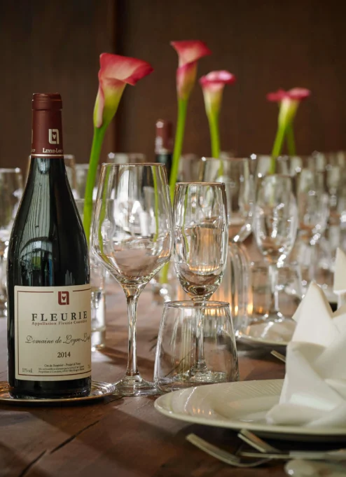 Elegant table setting with wine and flowers, perfect for a family gathering at a resort.