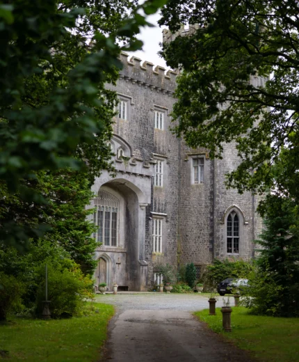 Family exploring historic stone castle in lush gardens