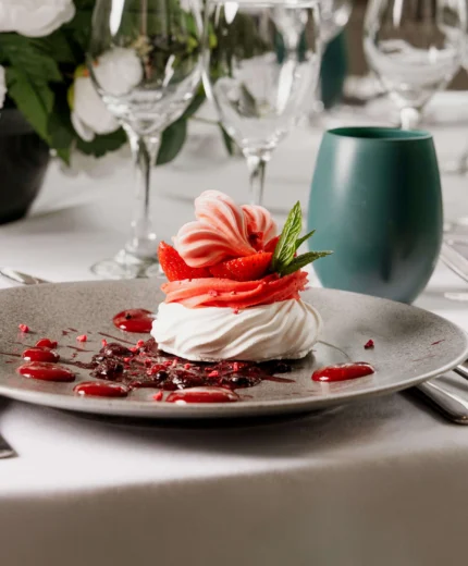 Elegant table setting with dessert in a luxurious hotel restaurant.