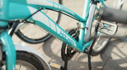 Turquoise bicycle parked outdoors, ready for a leisure ride.