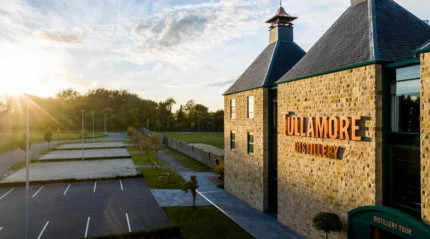 Early morning at a cosy distillery near a serene hotel, with a family enjoying a peaceful walk.