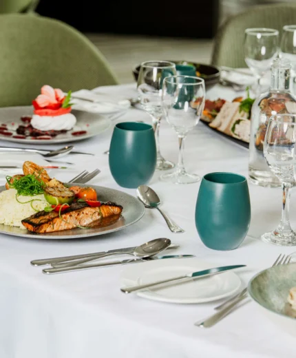 Elegant dining table with gourmet meals in a cosy, inviting restaurant setting.