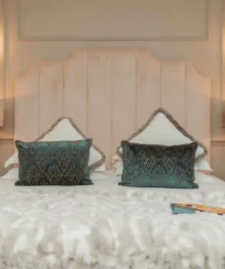 Elegant hotel room with plush bedding and soft lighting for a cosy stay.