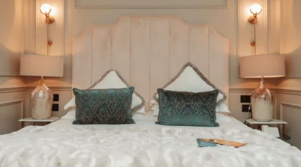 Elegant hotel room with plush bedding and soft lighting for a cosy stay.