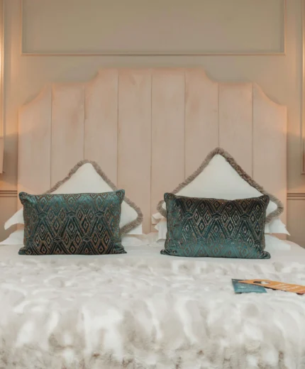 Elegant hotel room with plush bedding and soft lighting for a cosy stay.