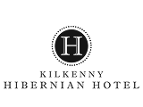 Family enjoying stay at a cosy hotel lobby, Kilkenny Hibernian Hotel logo visible.