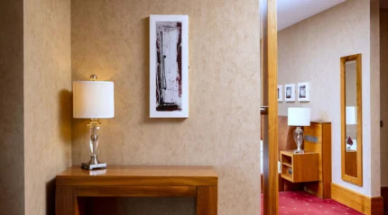 Welcoming hotel room with stylish decor and warm lighting.