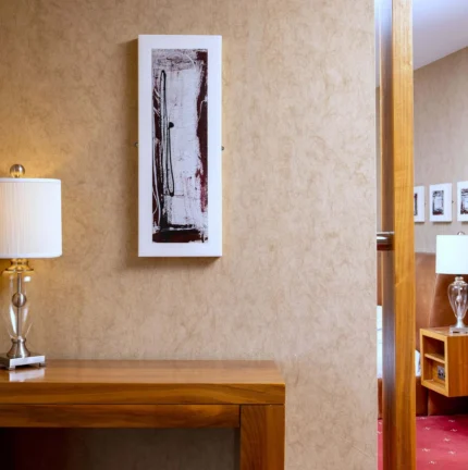 Welcoming hotel room with stylish decor and warm lighting.