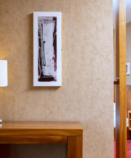 Welcoming hotel room with stylish decor and warm lighting.