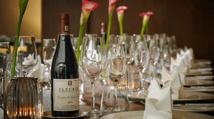 Elegant table setting with wine and flowers at a resort restaurant.