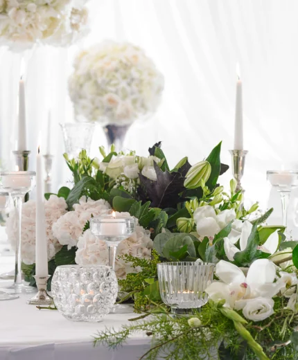Elegant table setting with floral centrepiece at a bright, inviting event space.