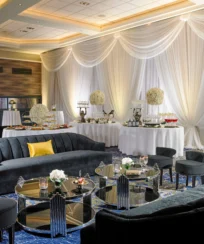 Elegant hotel lounge with plush seating and a lavish buffet setup.