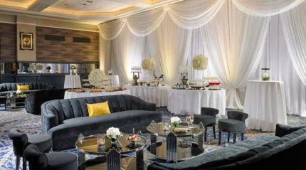 Elegant hotel lounge with plush seating and a lavish buffet setup.