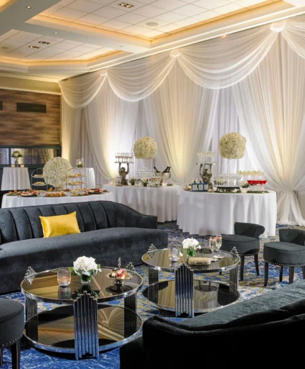 Elegant hotel lounge with plush seating and a lavish buffet setup.