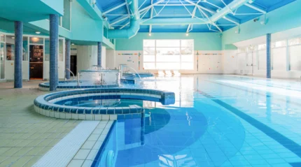 A serene indoor hotel pool with spa features, inviting guests to relax and unwind.