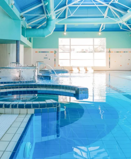 A serene indoor hotel pool with spa features, inviting guests to relax and unwind.