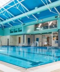 Spacious indoor pool in resort with natural light.