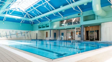 Spacious indoor pool in resort with natural light.