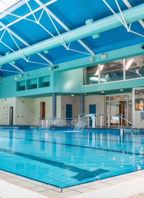 Spacious indoor pool in resort with natural light.