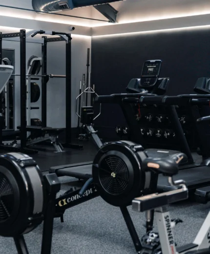 Modern gym in a hotel, with equipment and a warm, inviting atmosphere for family fitness.