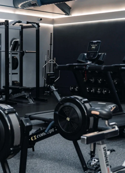 Modern gym in a hotel, with equipment and a warm, inviting atmosphere for family fitness.