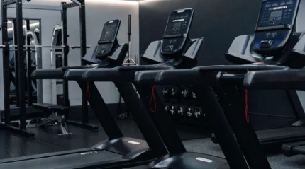 Modern hotel gym with treadmills and fitness equipment for guests