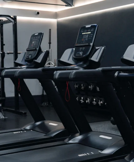 Modern hotel gym with treadmills and fitness equipment for guests