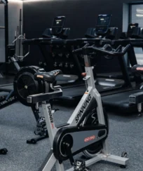 Modern hotel gym with spin bikes and treadmills, perfect for guest workouts.
