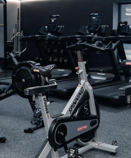 Modern hotel gym with spin bikes and treadmills, perfect for guest workouts.