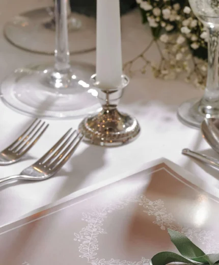 Elegant table setting with flower details and soft lighting.