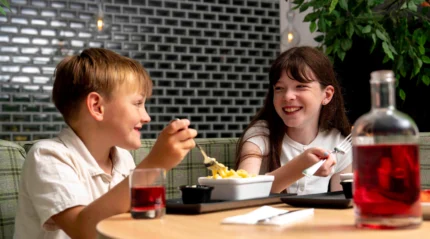 Siblings enjoying a meal together at a cosy restaurant.