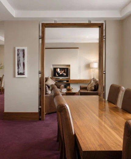 Family enjoying a warm, inviting hotel suite with modern furnishings.