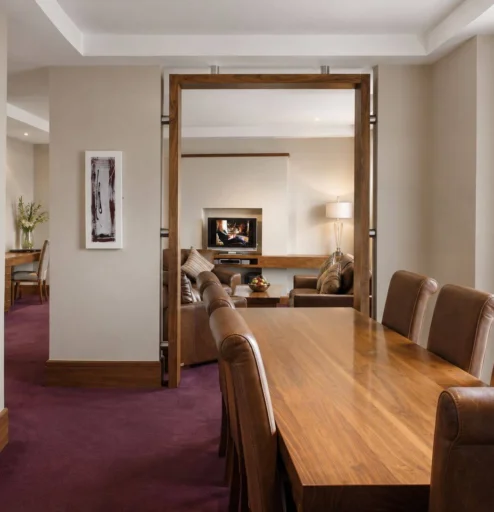 Family enjoying a warm, inviting hotel suite with modern furnishings.