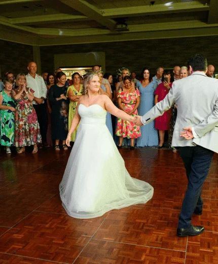 A couple dances surrounded by smiling guests at Tullamore Court Hotel wedding.