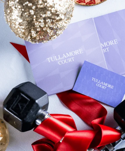 Festive decorations with Tullamore Court brochures and dumbbells.