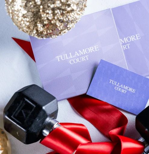 Festive decorations with Tullamore Court brochures and dumbbells.